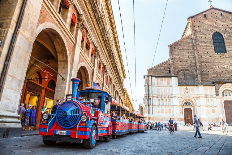 Bologna, Italy - May 28, 2016: Perspective view of San Luca Espress, an tourist line which connects the historic center with the Basilica of San Luca, at side of Palazzo dei Banchi in Piazza Maggiore.