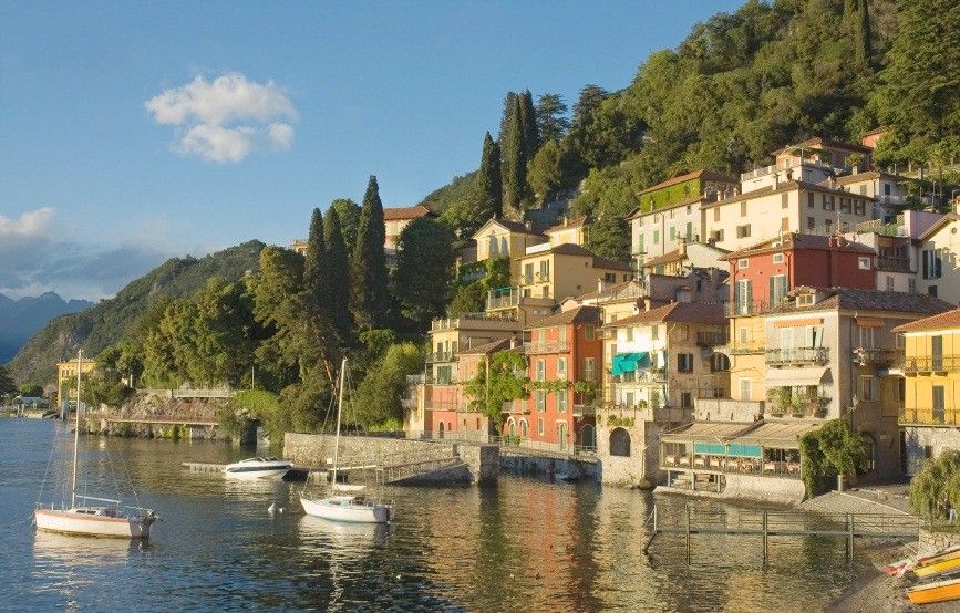 Hillside village of Varenna on the east shore of Lake Como, Italy, with boats just off the waterfront | Italian Lakes
