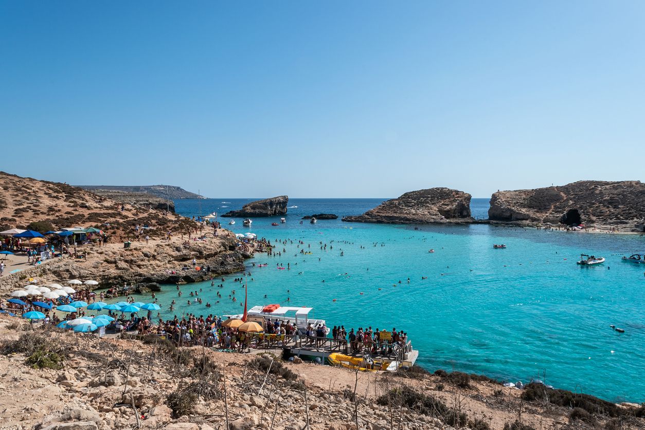 Blue Lagoon - Island of Comino - Malta. The Blue Lagoon on the tiny island of Comino with Gozo in the distance
