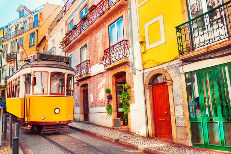 Yellow Vintage Tram On The Street In Lisbon, Portugal.