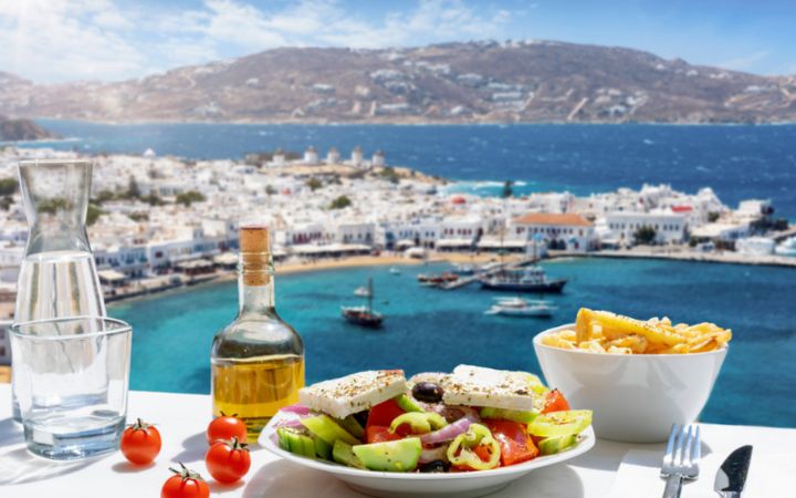 Greek Food with backdrop of Mykonos