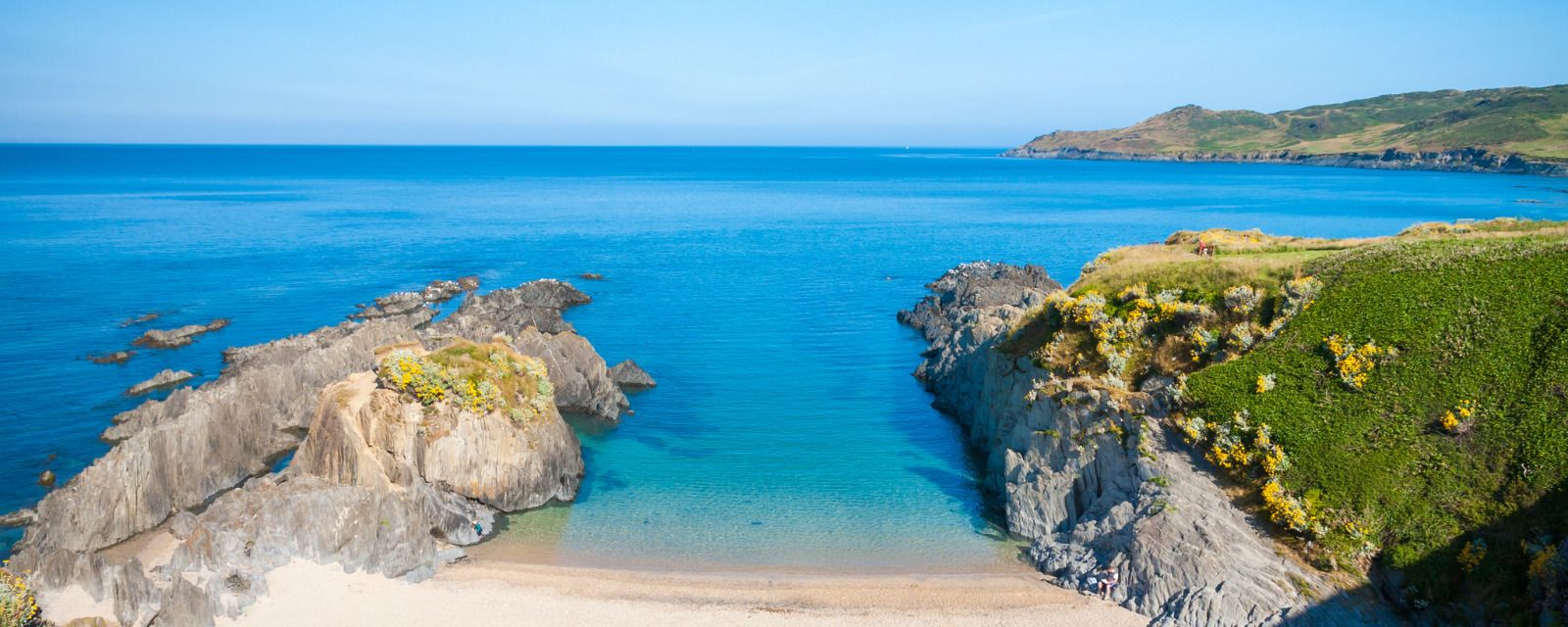 A sandy bay flanked by roack in Devon, England