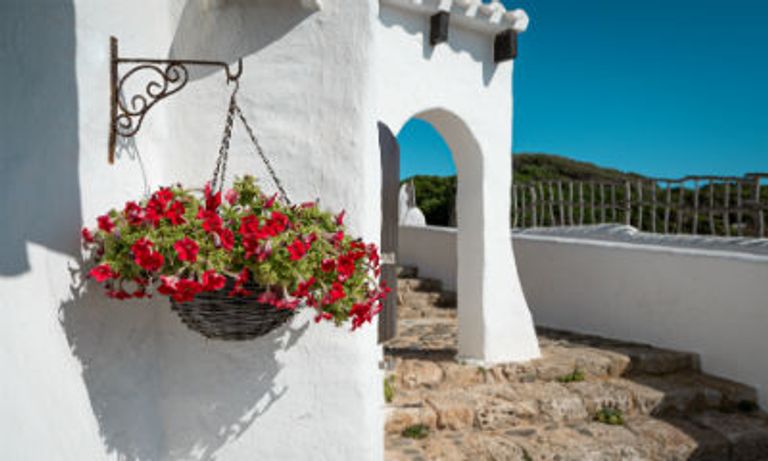 Terrace of white washed building in Binibeca, Menorca