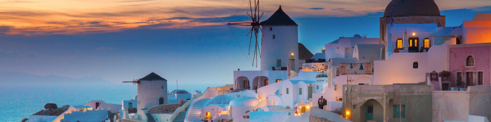 Whitewashed houses against the sunset in Santorini