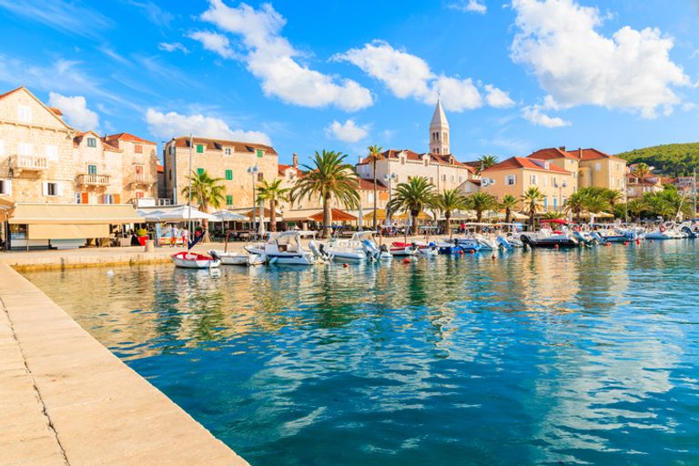 View Of Supetar Port With Boats And Colorful Houses