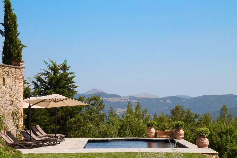 Villa pool with umbrella and sunloungers