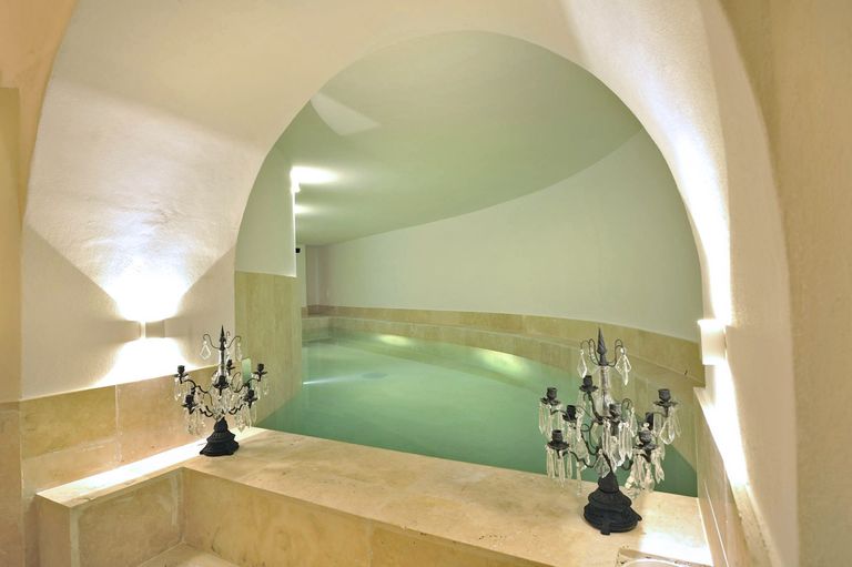 Spa bathroom with pool and toilet