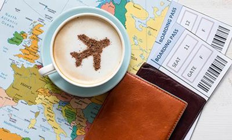 Airplane made of cinnamon in cappuccino. Passports and Europe map