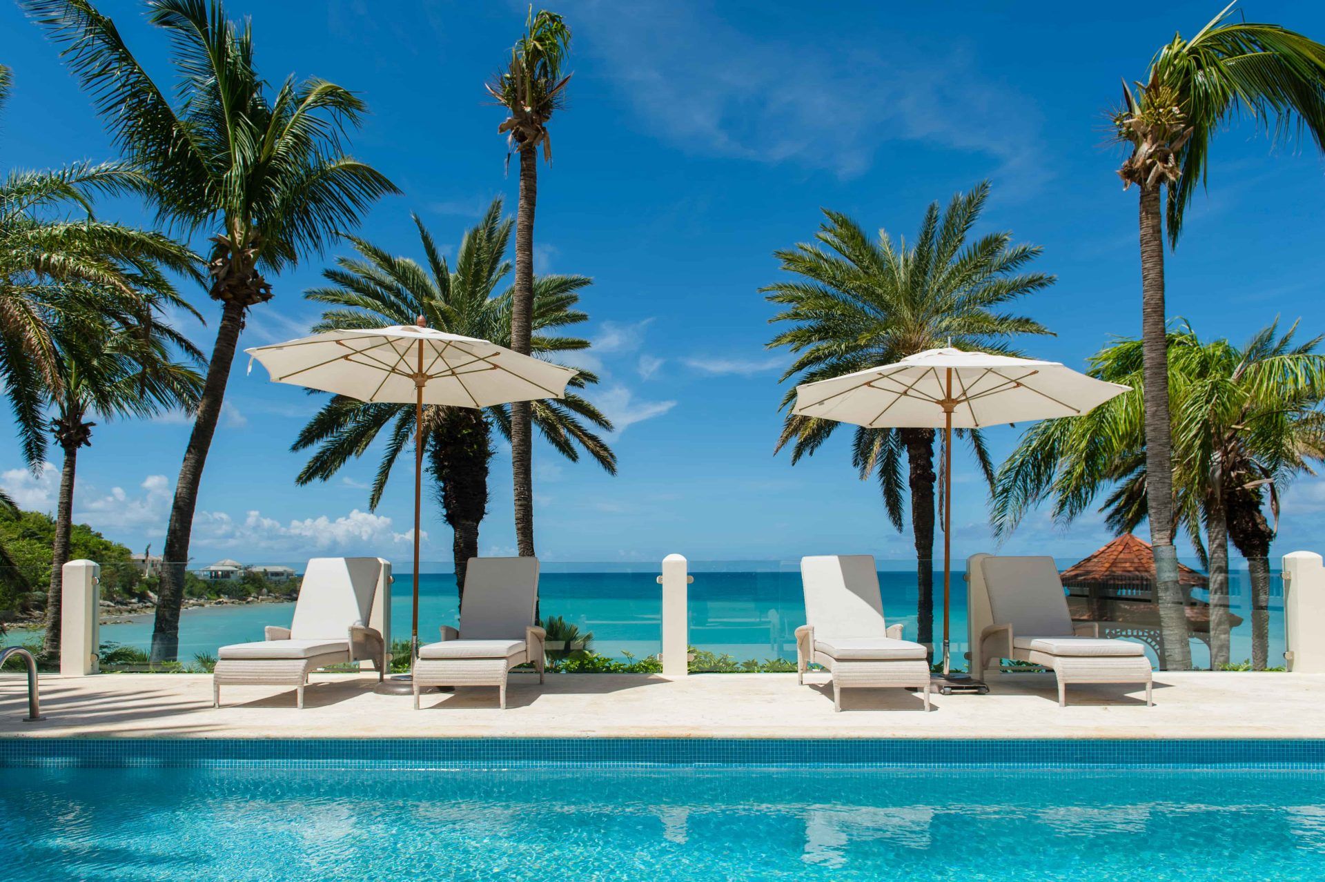 Pool by the ocean with sun loungers