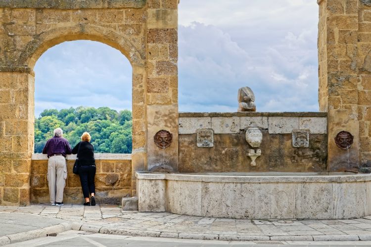 Elderly couple watching the view from the village of Pitigliano, Tuscany | best group activities in Tuscany