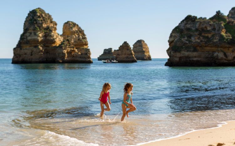 Children running at the beach, Praia da Boneca, Lagos, Portugal