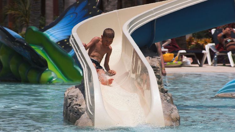 Boy on waterslide - iStock