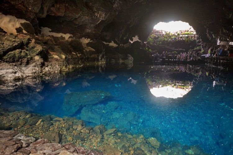 Unidentifiable Tourist visiting famous cave Los Jameos del Agua in Lanzarote, Canary islands, Spain.