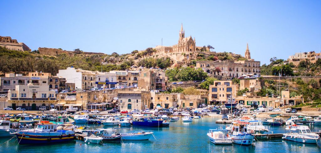 Beautiful view on Gozo island from a boat, postcard style, beautiful colors landscape, in the background you can see old buildings