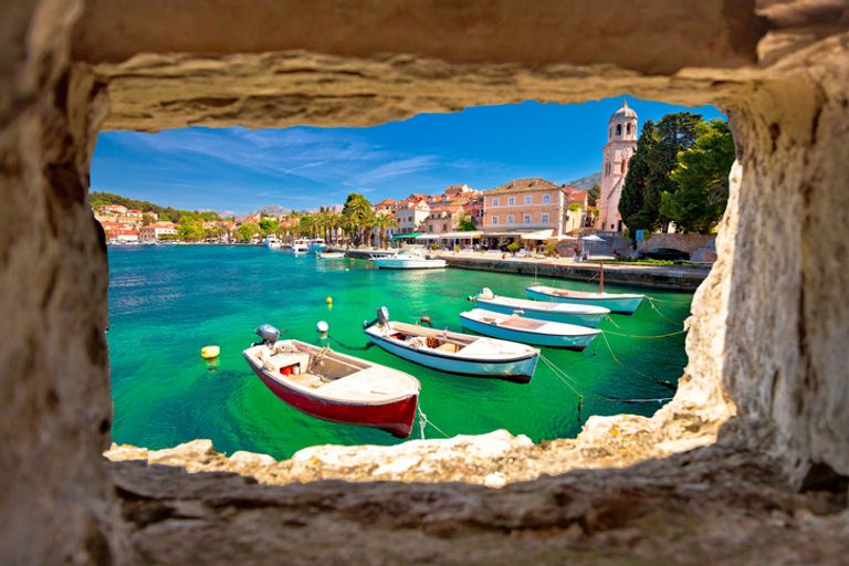 Waterfront view of Cavtat through a stone window