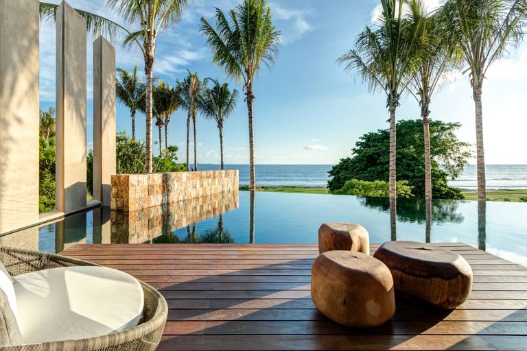 balcony with pool, sea view and palm trees