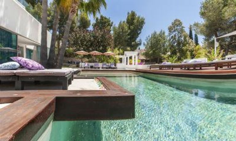 outdoor pool with wooden details, amongst trees