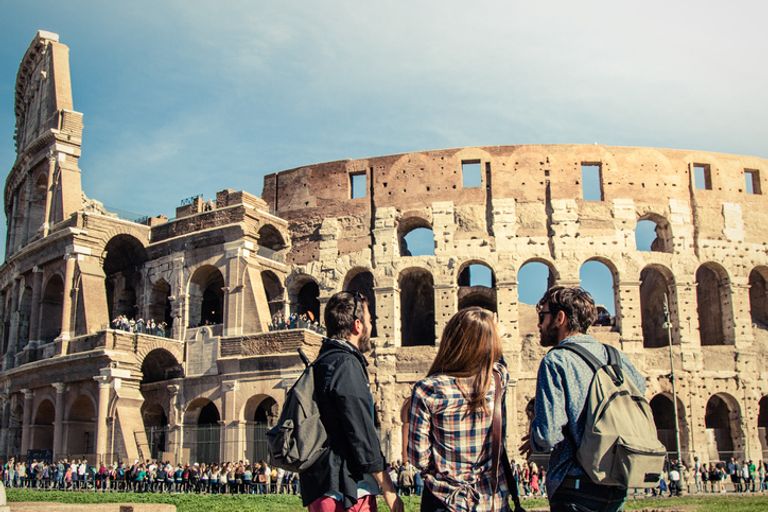 Three people looking at the Colleseum, Rome