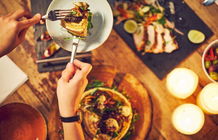 Hand serving dinner from a platter